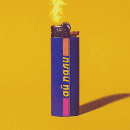 a lighter with a lit top is placed against a blue background