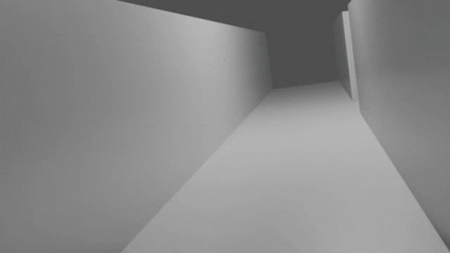 a black and white po of a person walking down a hallway