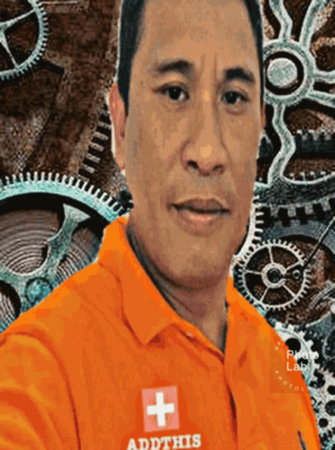 a guy in front of an image of some mechanical gears
