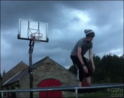 the man stands outside near a basketball hoop