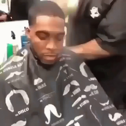 a man in a hair cut getting his hair done