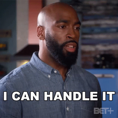 a bald black man is with a beard and there is a text that says i can handle it