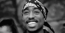 a man wearing an old bandana smiles