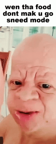 an image of a bald man holding a beer