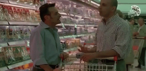 two men are standing near each other at a store