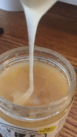 an open cup filled with liquid sitting on a table