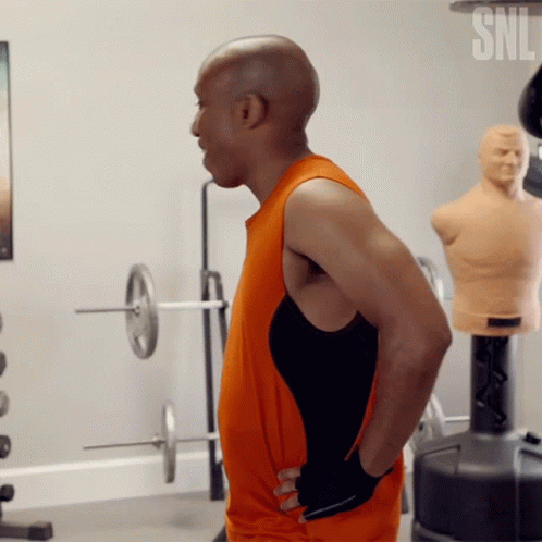 a male bodybuilding coach is looking down at his torso