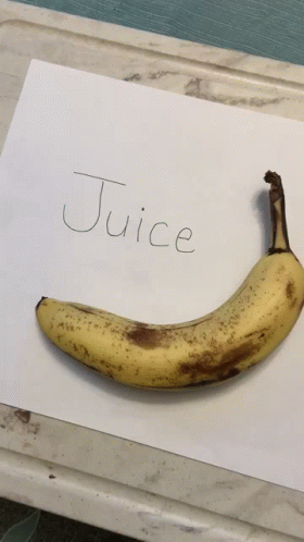 a handwritten note with a small blue banana sitting on top