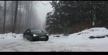 a car is driving on a snowy road