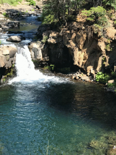 the waterfall has brown water flowing down it