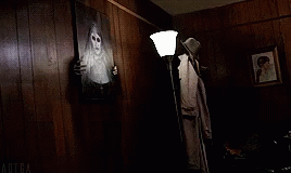 the creepy person has the shadow of a ghost in the corner