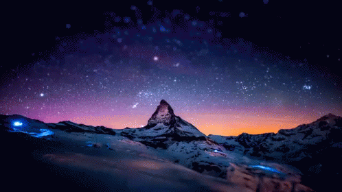 a mountain range in the foreground with stars