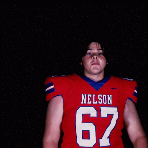 a football player with a blue uniform on and red letters that read nelson 6