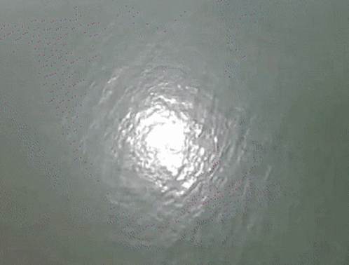 an aerial view of the water and the light reflected in it