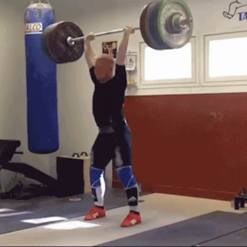 a woman is doing squat lifts while holding a barbell