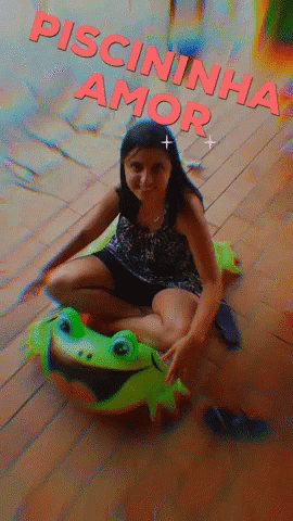 a girl sitting on a toy with a stuffed lizard