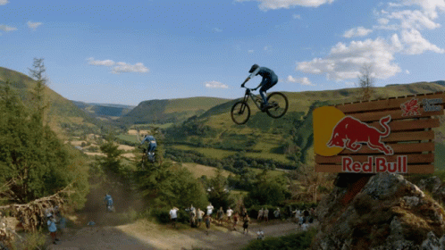a guy jumping a mountain bike over rocks and into the air