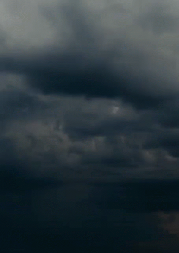 the dark clouds are in the sky, and two planes are just landing