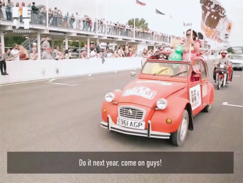 a parade that has some cars being driven by people