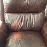 a blue leather chair that is in the living room