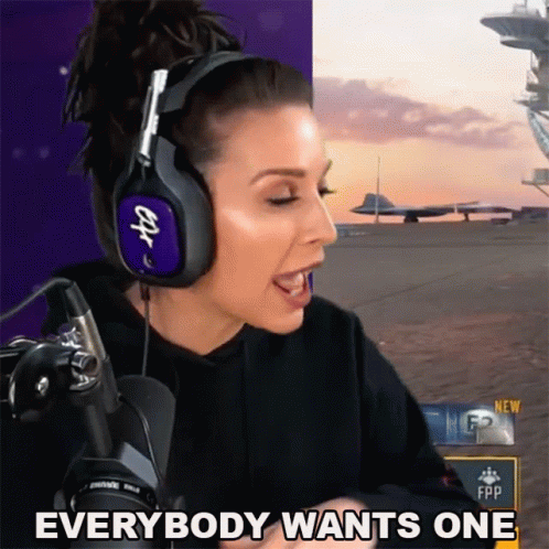 a girl wearing headphones and yelling in front of a camera