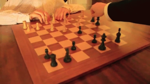 someone playing chess on the table