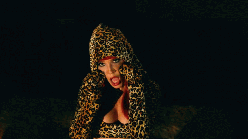 a female in a animal print jacket on a cell phone