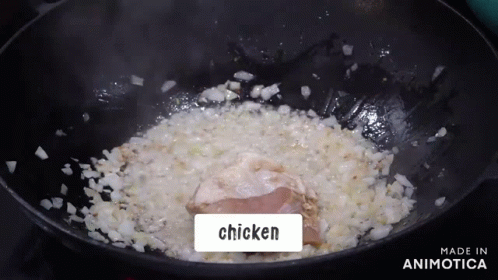 chicken is being cooked in a small black bowl