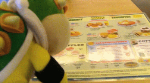 an octo toy standing next to a menu