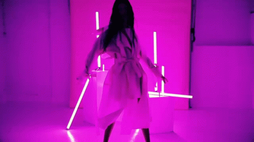 a person is walking in an area with fluorescent light