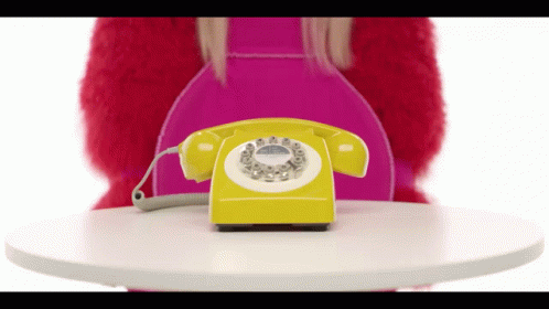 a person in blue jacket holding onto a telephone