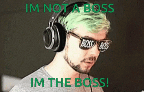 a guy with headphones and a green sticker saying i'm not a boss