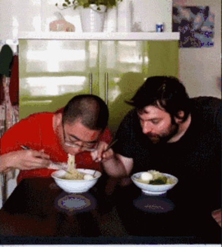 the two people are eating out of bowls