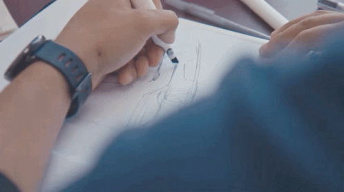 person signing in their drawings on a piece of paper