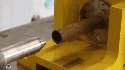 a big machine in action on a piece of wood