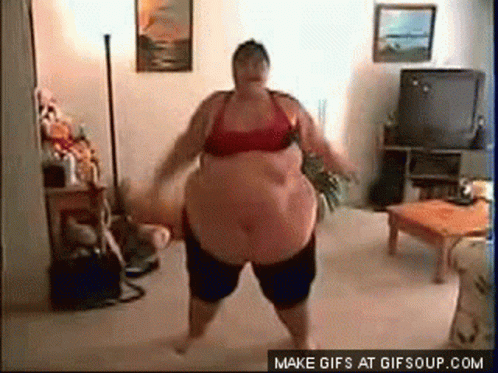 an overweight woman stands in front of a tv and the floor is white