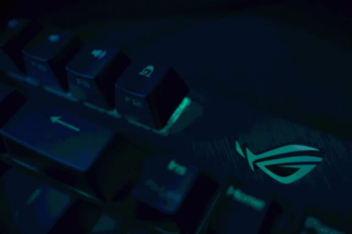 an illuminated keyboard with the image of the asus logo on it