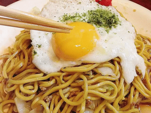 noodles with egg and turquoise sauce on a plate