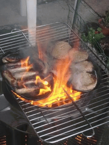 a close - up of a blue flames cooking in a black grill
