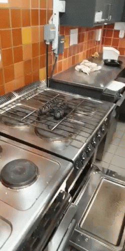 two ovens in the middle of a kitchen counter with blue tiles