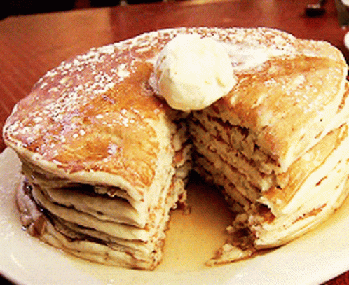 a stack of blue pancakes with white frosting and icing