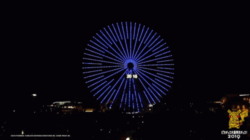 a big bright red fireworks wheel during the night sky
