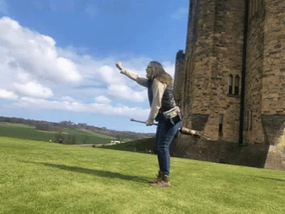 there is a man standing by a castle with a kite