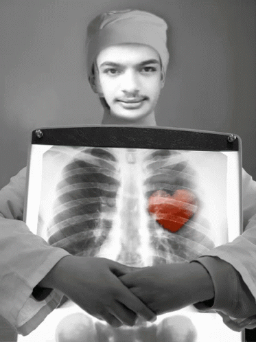 a young man holding a x - ray print showing his stomach