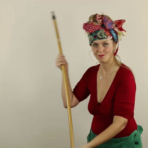 a blue woman with a costume on holding a brush