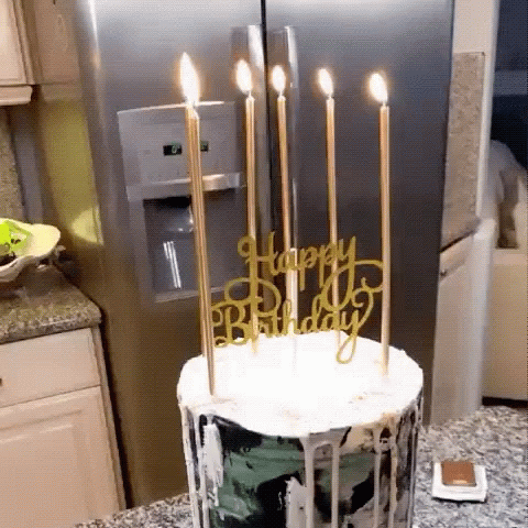 a birthday cake with candles on top is sitting on the counter