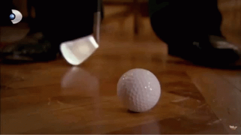 golf ball on the ground with one being hit by a club