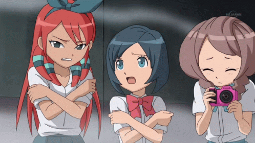 three anime women looking at a camera screen