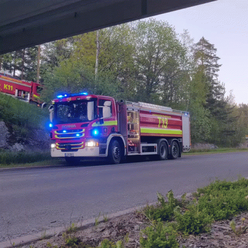 a truck travels under a bridge in front of the road