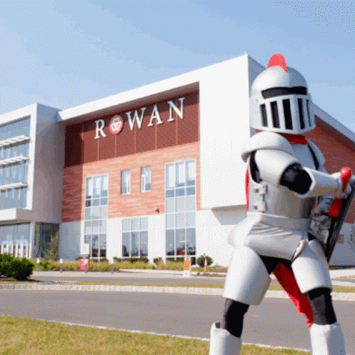 a person in white robot suit standing in front of a building